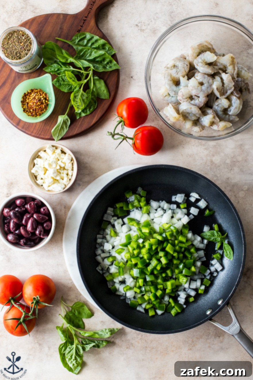 Greek-Style Baked Shrimp with Feta and Olives 3 Overhead photo of a skillet filled with chopped green bell peppers and onions, surrounded by bowls of fresh raw shrimp, Kalamata olives, and crumbled feta cheese