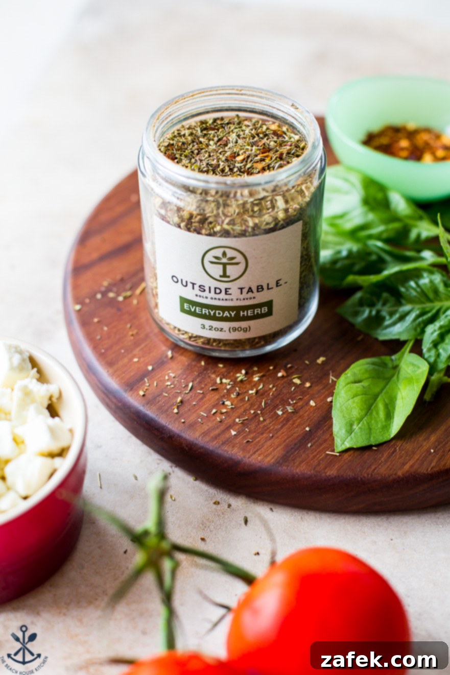 Greek-Style Baked Shrimp with Feta and Olives 6 Up close photo of a jar of Outside Table Everyday Herb Seasoning Blend, showcasing its label and texture