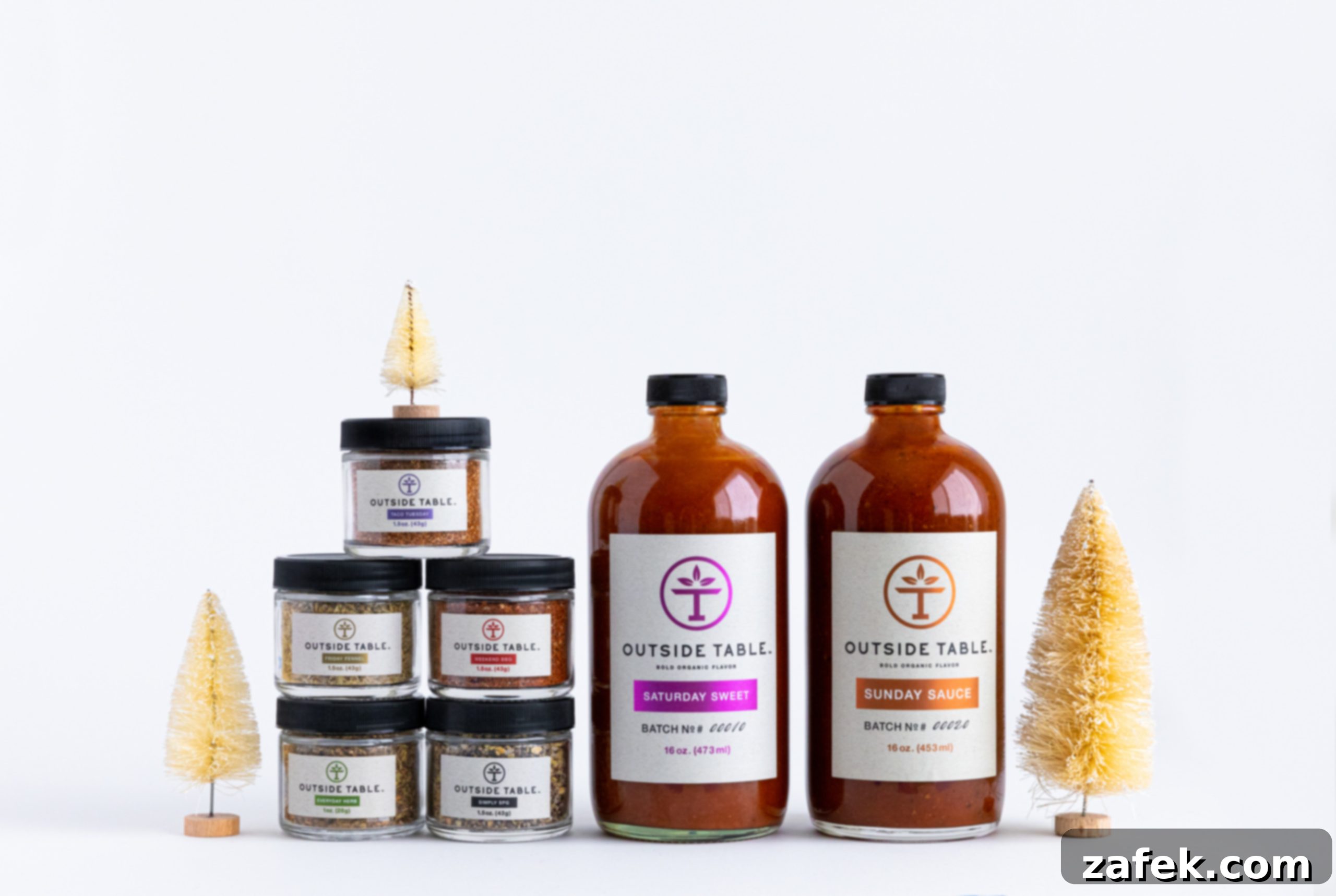 Greek-Style Baked Shrimp with Feta and Olives 9 A photo of 5 small spices containers and two large jars of sauce by Outside Table, showcasing the brand's product line