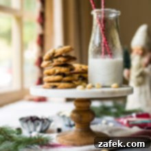 A cake stand topped with cookies and a bottle of milk