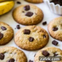Decadent Bananas Foster Chocolate Chunk Cookies 7 Chocolate chunk cookies with two bananas in the background and a bowl of chocolate chunks