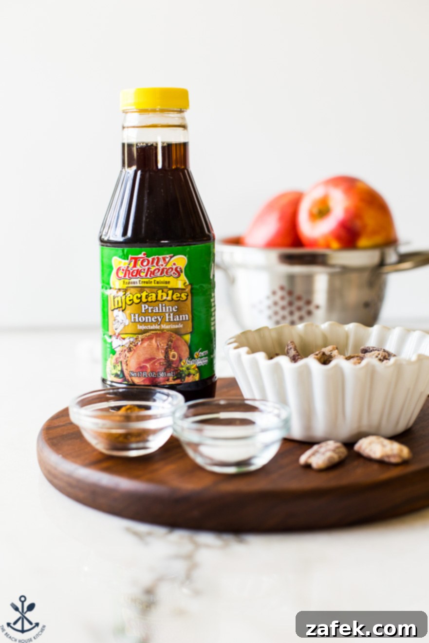 Golden Apple Praline Muffins 5 A striking close-up photograph of Tony Chachere's Praline Honey Ham Marinade bottle, elegantly positioned on a rustic wooden board. The bottle is the focal point, with a soft blur of fresh, ripe apples in the background, subtly emphasizing the main flavor inspiration for the muffins.