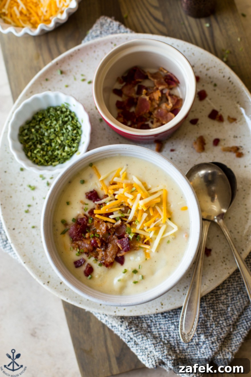 Bacon Cheddar Baked Potato Soup 2 Up close overhead photo of a bowl of soup topped with bacon and cheese