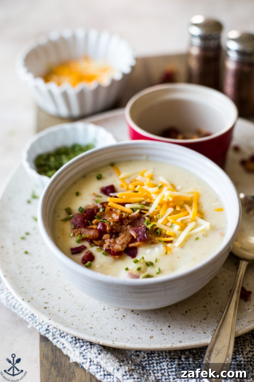 Bacon Cheddar Baked Potato Soup 7 Up close photo of a bowl of potato soup topped bacon and cheese