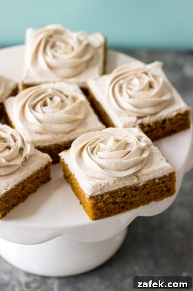 Close-up of a single Pumpkin Square, showcasing its moist texture and perfect frosting swirl