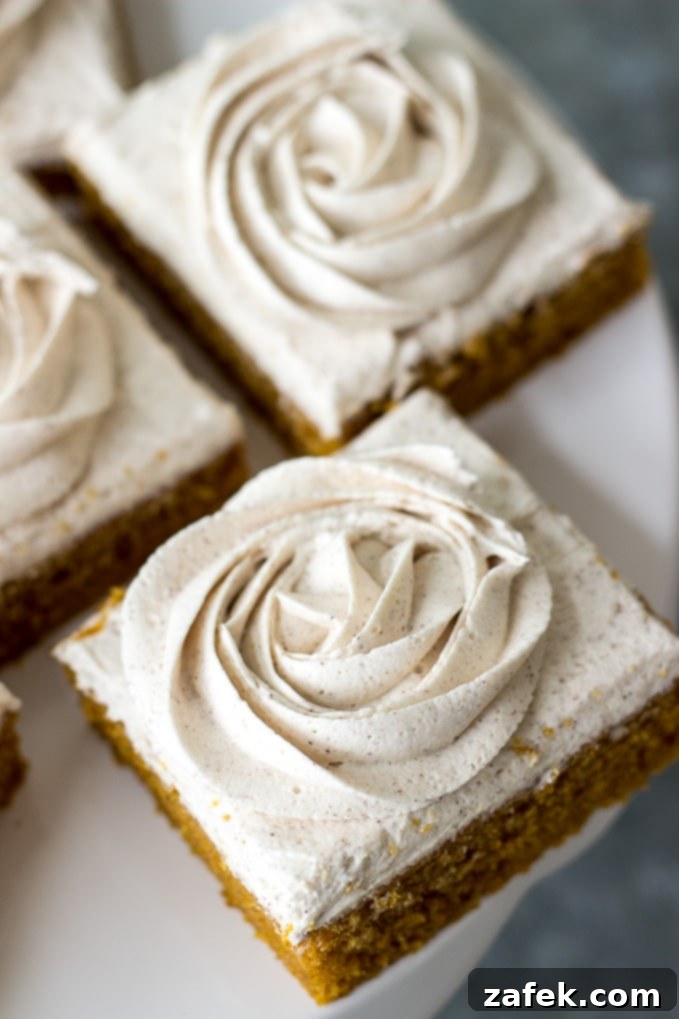 A tray of beautifully arranged Pumpkin Squares, each with a delicate buttercream rose on top