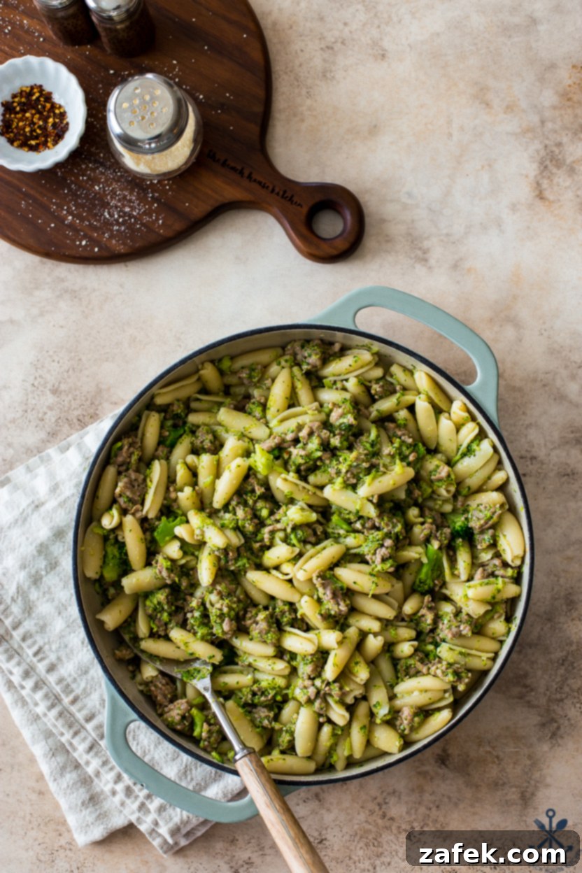 Overhead photo of a skillet with cavatelli Italian sausage and broccoli