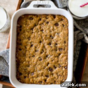 Chewy Oatmeal Chocolate Chip Bars 7 Overhead photo of a white baking dish of chocolate chip oatmeal bars, perfectly baked and ready to be cut