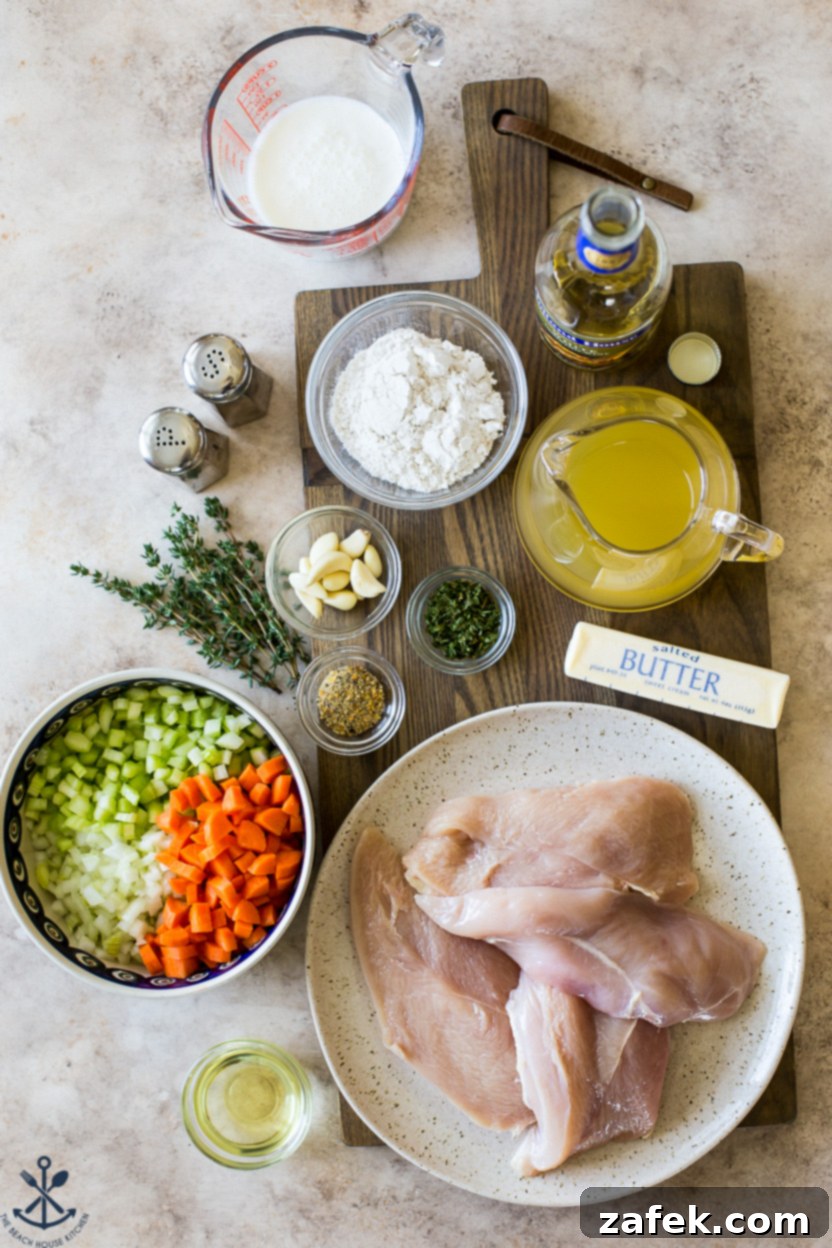 Garlic Chicken Delight 3 Overhead photo of fresh ingredients for chicken dish laid out on a wooden board, including chicken, herbs, and vegetables