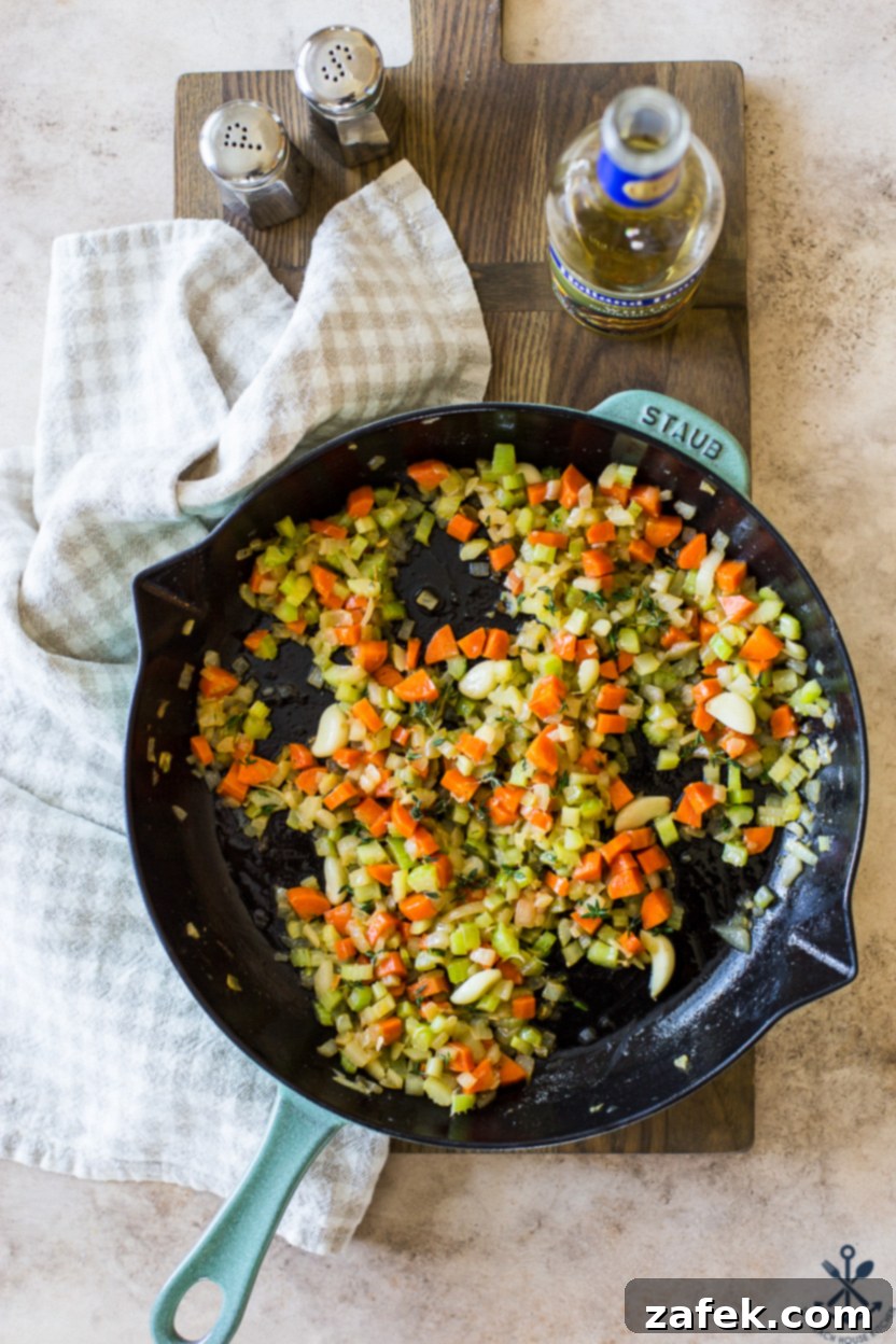 Garlic Chicken Delight 6 Overhead photo of a skillet with cooked chopped carrots, onions, and celery, ready for the next step