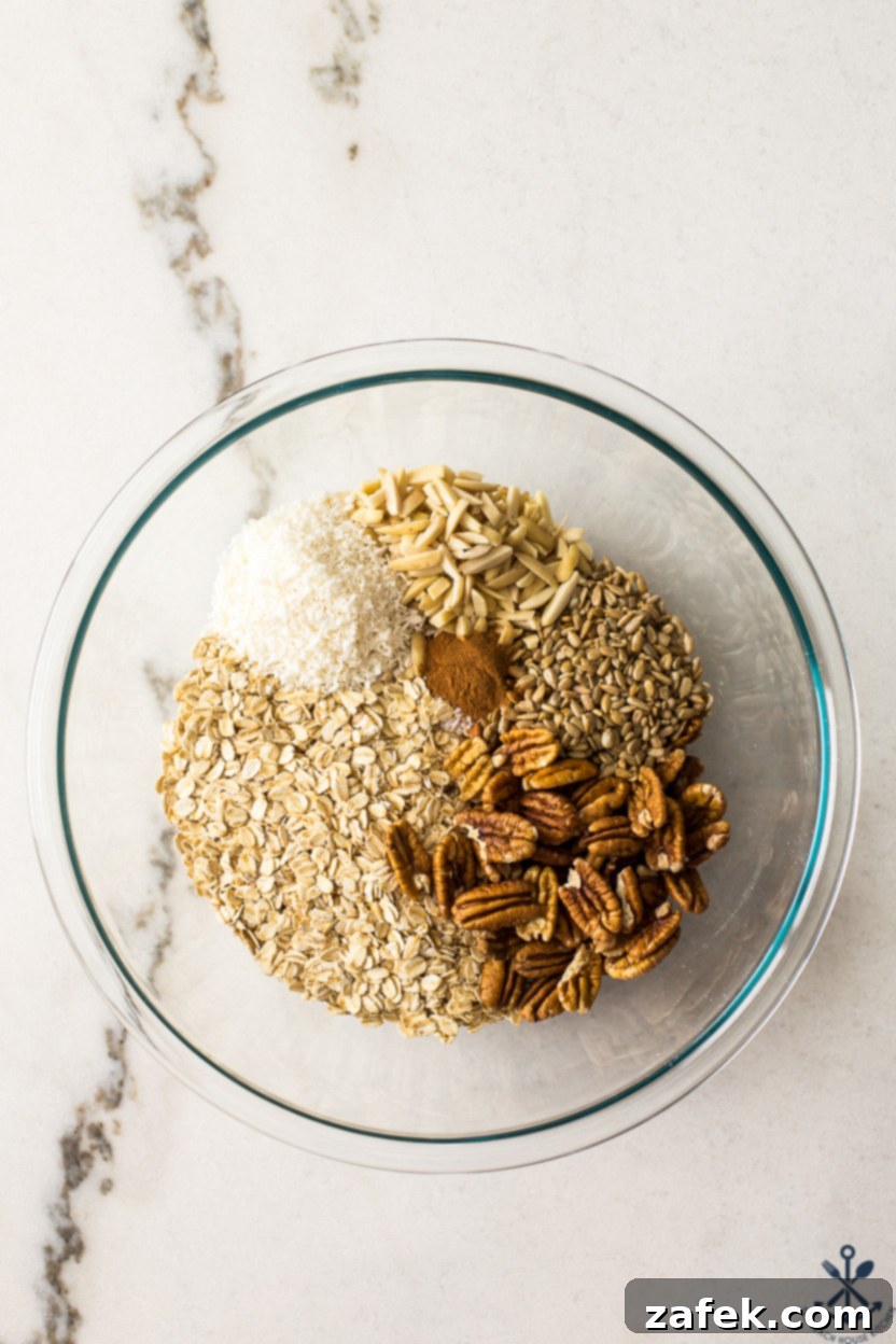 Sunshine Lemon Berry Crunch 6 Overhead photo of a glass bowl filled with oats, nuts, coconut, sunflower seeds and cinnamon