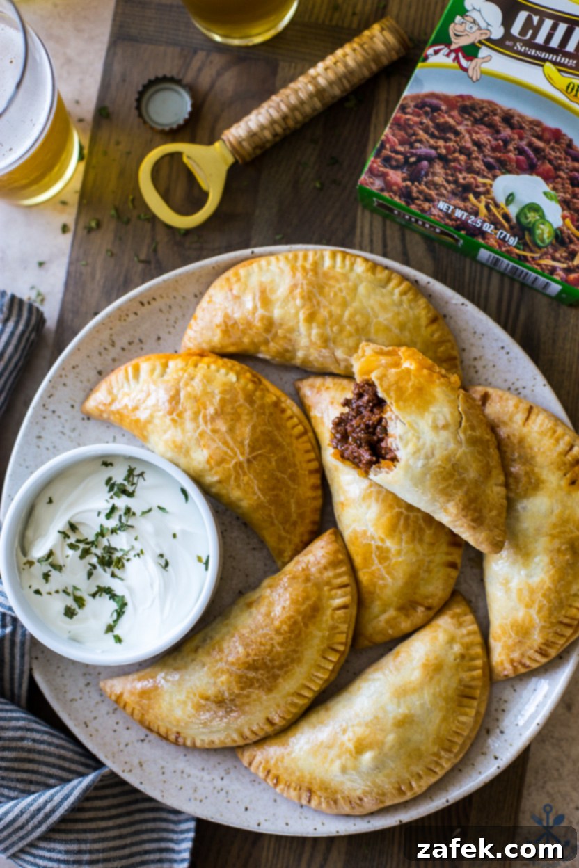 Spicy Cheesy Empanadas 2 Delicious Baked Chili Cheese Empanadas on a plate, ready to be served.