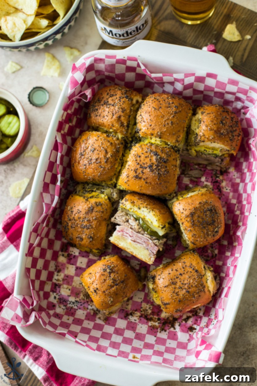 Savory Cuban Mini Sandwiches 2 Overhead photo of a baking dish of Cuban Sliders, showcasing their golden-brown tops and fillings.