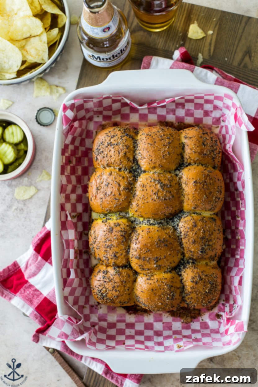 Savory Cuban Mini Sandwiches 6 Overhead photo of sliders in a baking dish lined with red and white checked parchment paper, ready to be served.