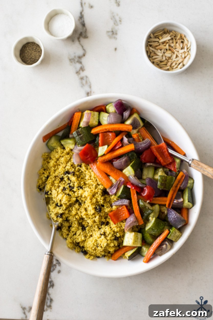 Overhead photo of a round dish of cooked couscous and roasted vegetables