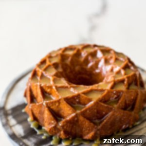 A perfectly baked brown sugar bundt cake with caramel glaze, ready to be served, capturing its rich color and glistening topping.