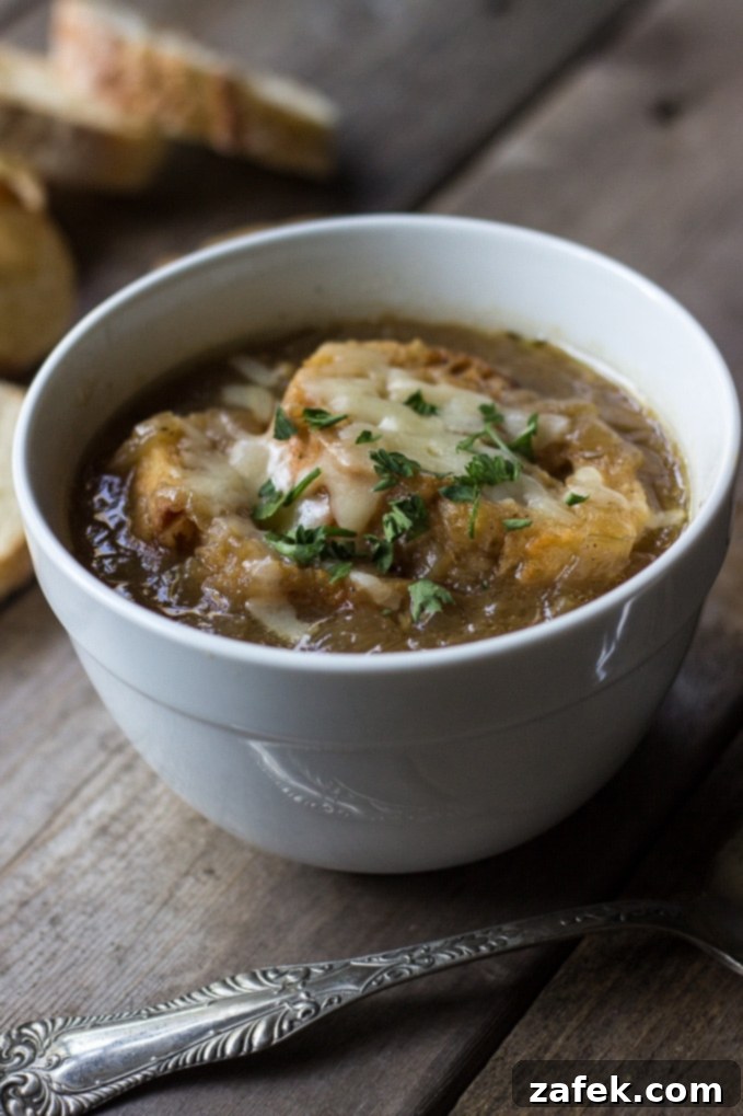 Close-up of golden brown caramelized onions simmering in a Dutch oven