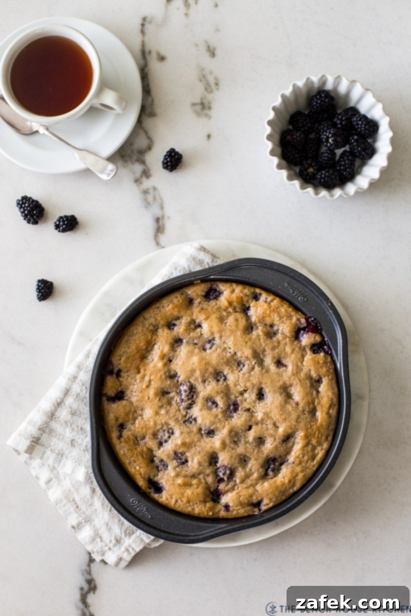 Overhead photo of a blackberry lime slump in a round cake pan