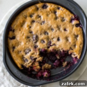 Overhead photo of a blackberry lime slump in a round baking pan