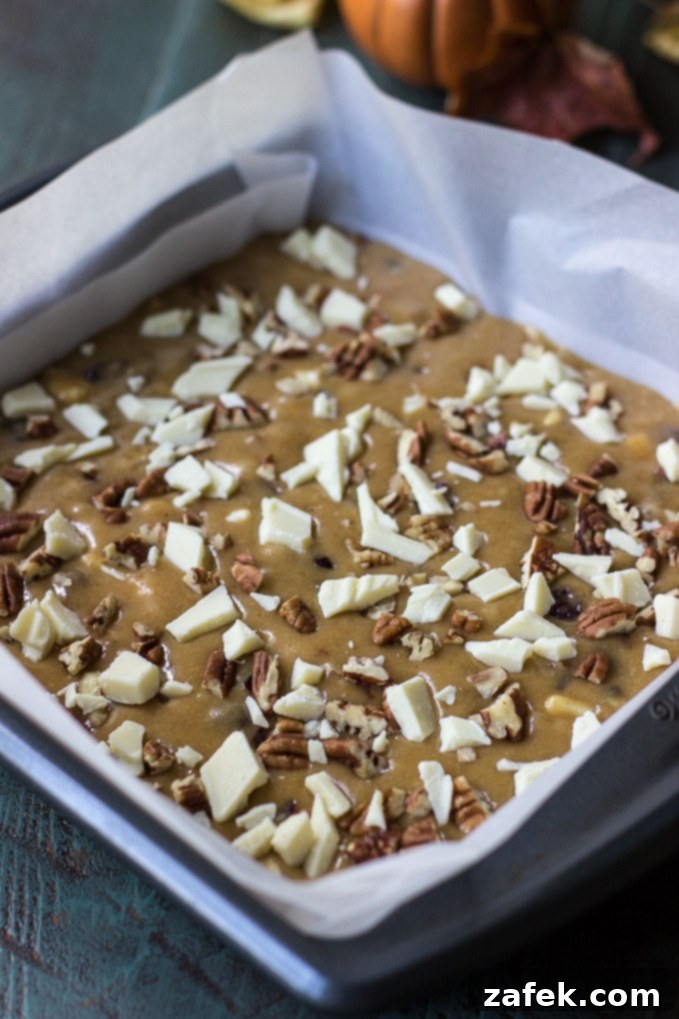 Stack of freshly baked Brown Butter Cranberry White Chocolate Pecan Blondies