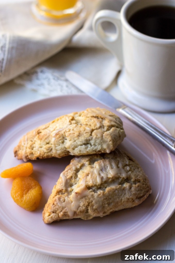 Maple Kissed Apricot Walnut Scones 7 Overhead view of a single Apricot Walnut Scone with a close-up on the glaze