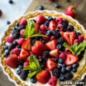 Vibrant Berry Tart 11 Overhead photo of a fresh berry tart on a wooden board