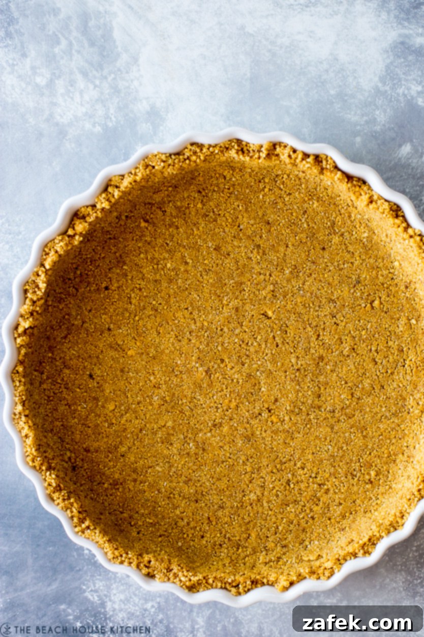 Vibrant Berry Tart 6 Up close overhead photo of a perfectly pressed graham cracker crust in a tart pan, ready for filling