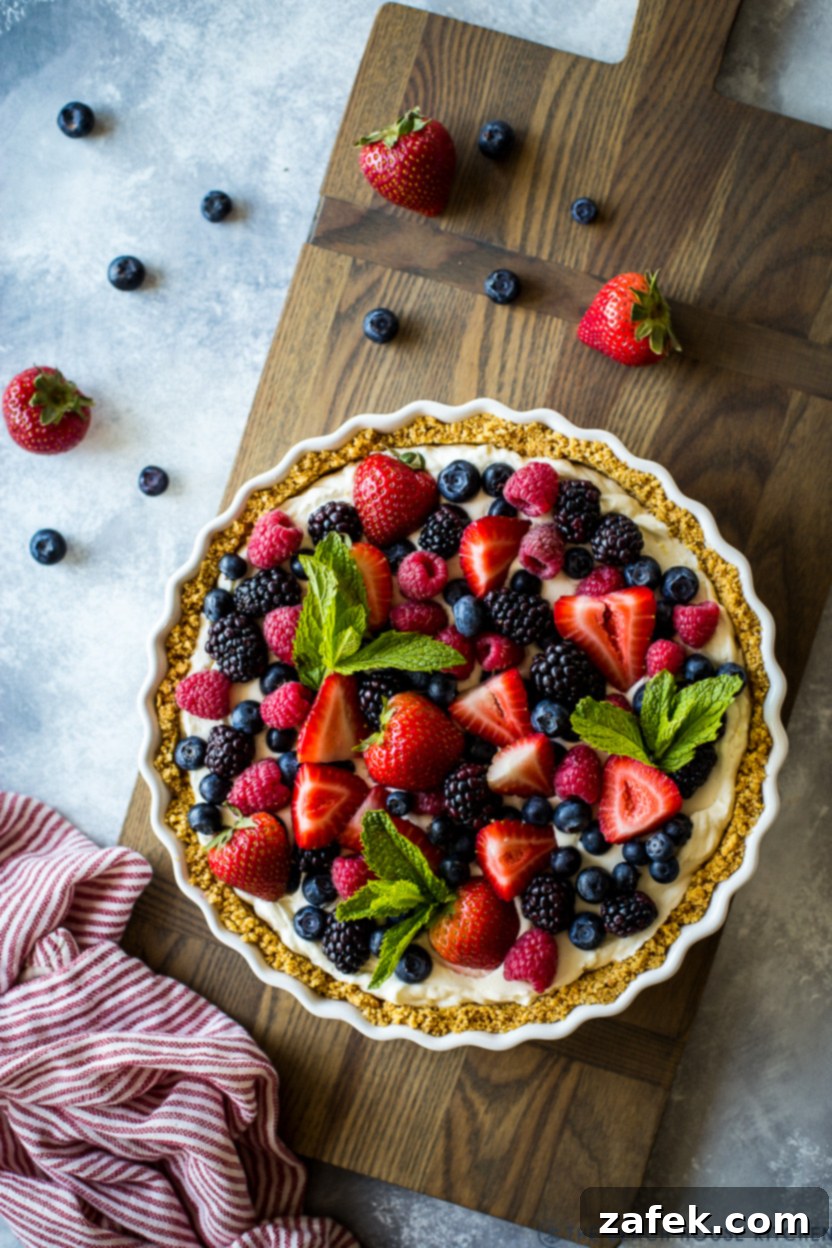 Vibrant Berry Tart 10 Overhead photo of a whole berry tart on a wooden board, ready to be served