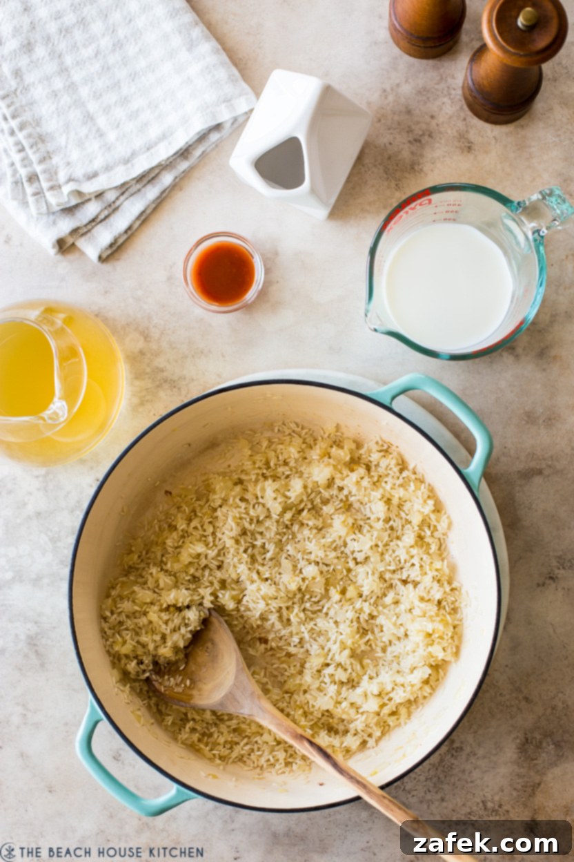 Creamy Chicken and Broccoli Rice Casserole 5 Overhead photo of a cast iron baking pan filled with rice and onions