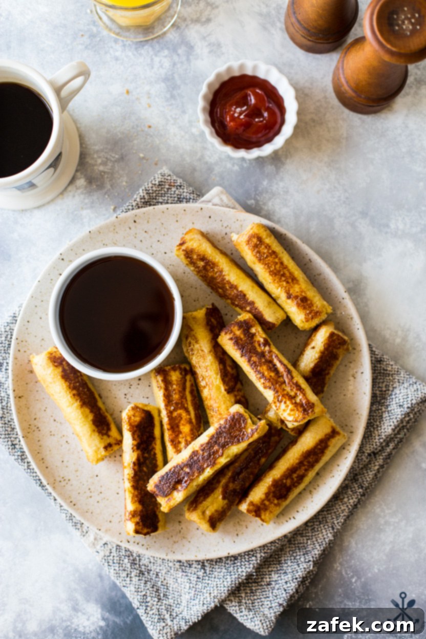 Overhead photo of a plate of French toast roll-ups, golden brown and ready to eat, perfect for a quick and easy back to school breakfast