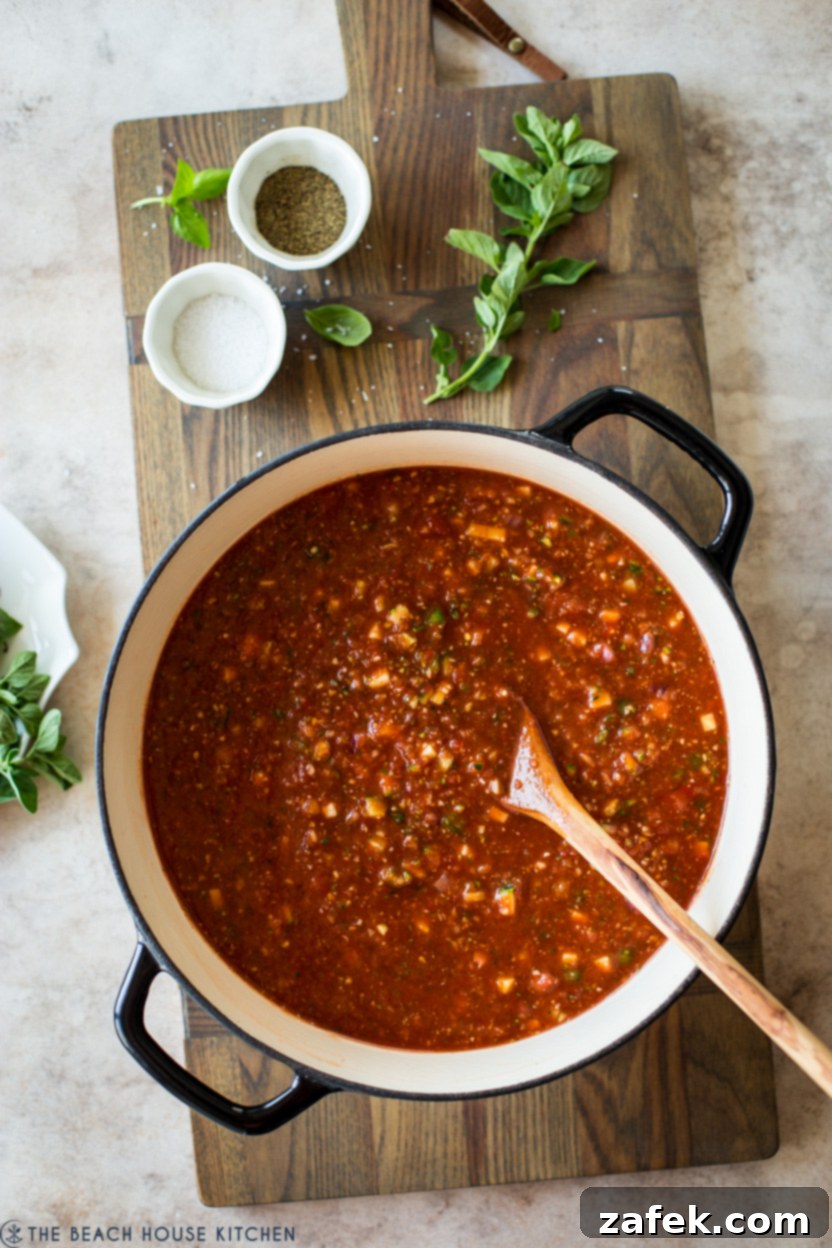 Overhead photo of a large pot of chilled gazpacho soup, ready for serving.