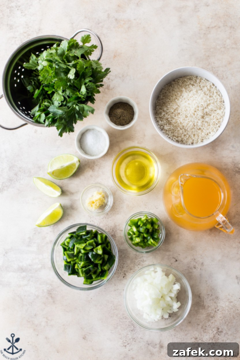 Overhead photo showing all the fresh ingredients for Arroz Verde, including poblano peppers, jalapeños, fresh parsley, cilantro, onion, garlic, and white rice on a wooden board.