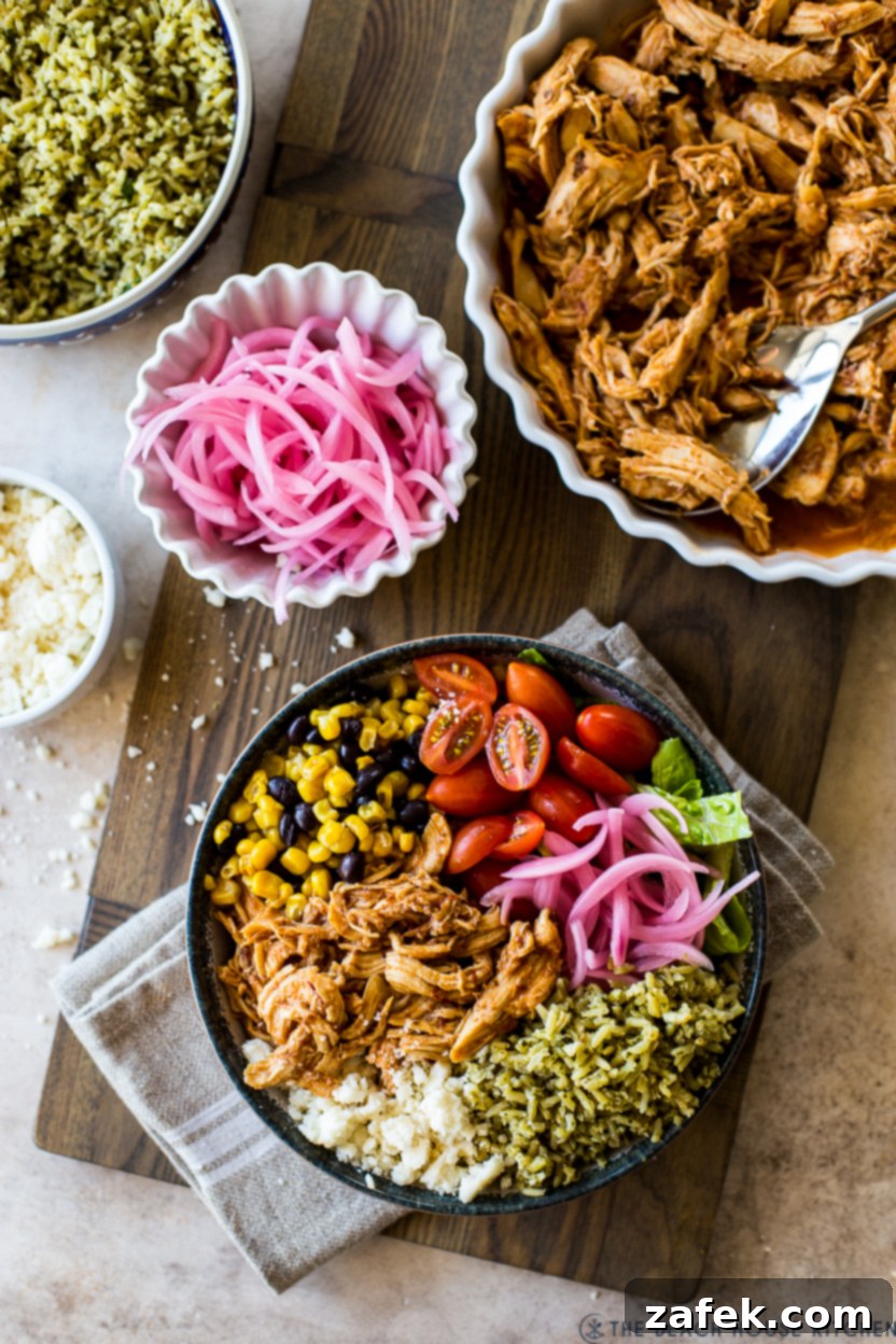 Overhead shot of two vibrant Honey Chipotle Chicken Bowls, featuring zesty chicken, green rice, and pickled red onions, ready to be enjoyed.