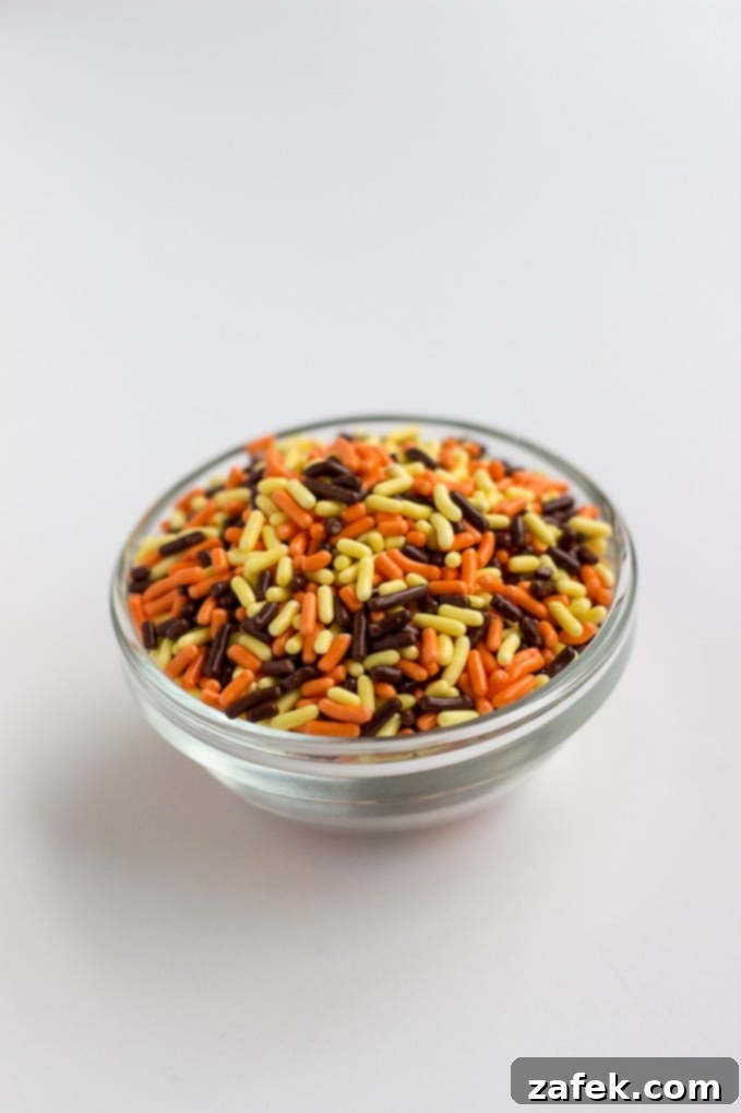 Close-up of freshly baked Classic Sprinkled Sugar Cookies with colorful Halloween sprinkles.