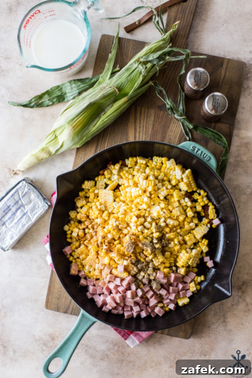 Overhead photo of a skillet filled with corn, spices and ham