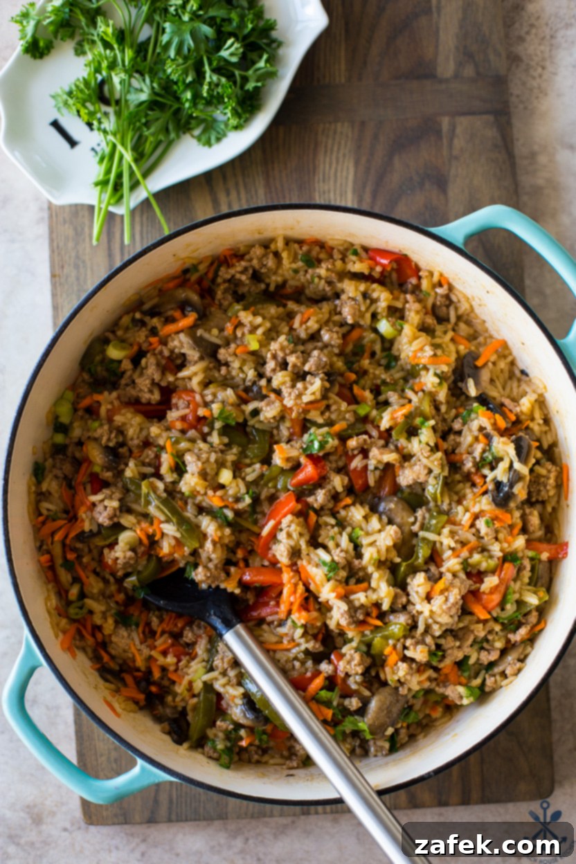 Zesty One-Pan Thai Pork Stir-Fry 2 Overhead photo of a baking dish of rice, vegetables and ground pork