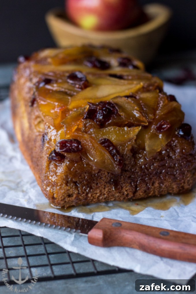 Sticky Caramel Apple Cranberry Upside-Down Loaf 5 Caramelized Apple Cranberry Upside Down Bread ready to be served on a rustic platter.