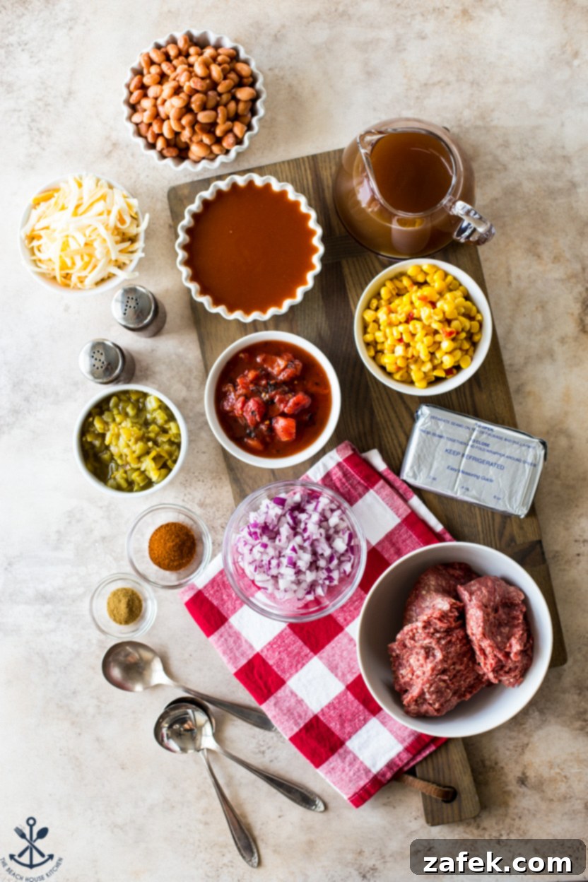 Overhead photo of slow cooker beef enchilada soup ingredients on a wooden board