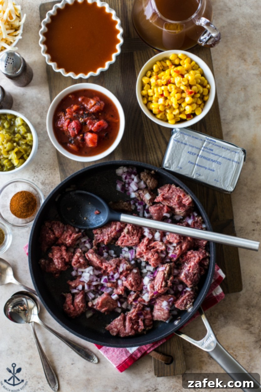 Overhead photo of a skillet filled with ground beef and red onions