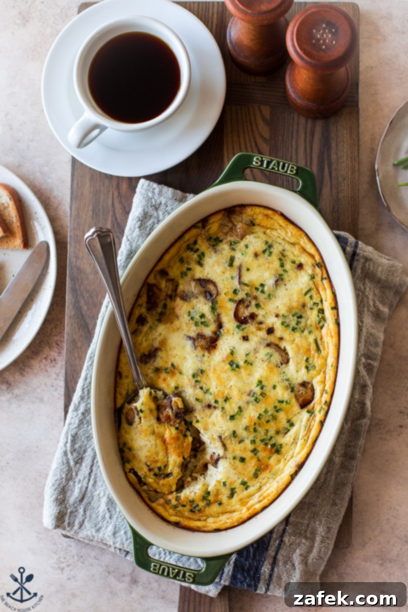Savory Mushroom Cloud 4 Overhead photo of a crustless quiche, partially sliced, showing the rich egg and mushroom filling, still in an oval baking dish