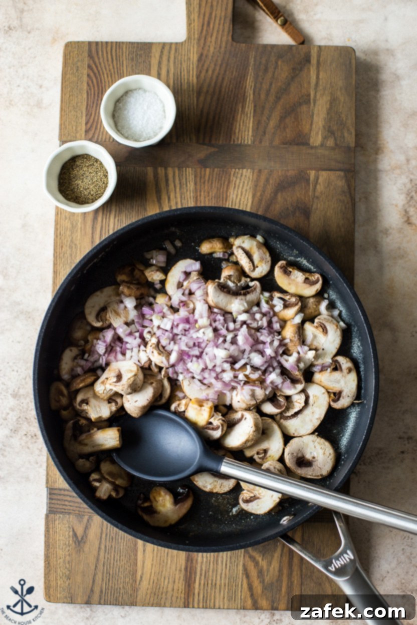 Savory Mushroom Cloud 5 Overhead photo of a skillet filled with pre-cooked mushrooms and chopped shallots, still on the stovetop