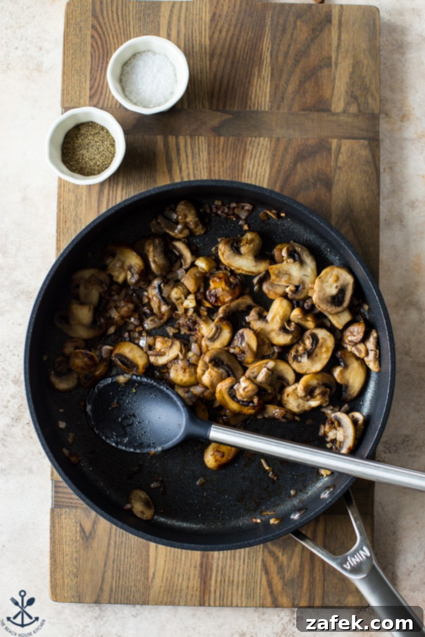 Savory Mushroom Cloud 6 Overhead photo of a skillet filled with browned and tender mushrooms and onions after sautéing, ready for the next step