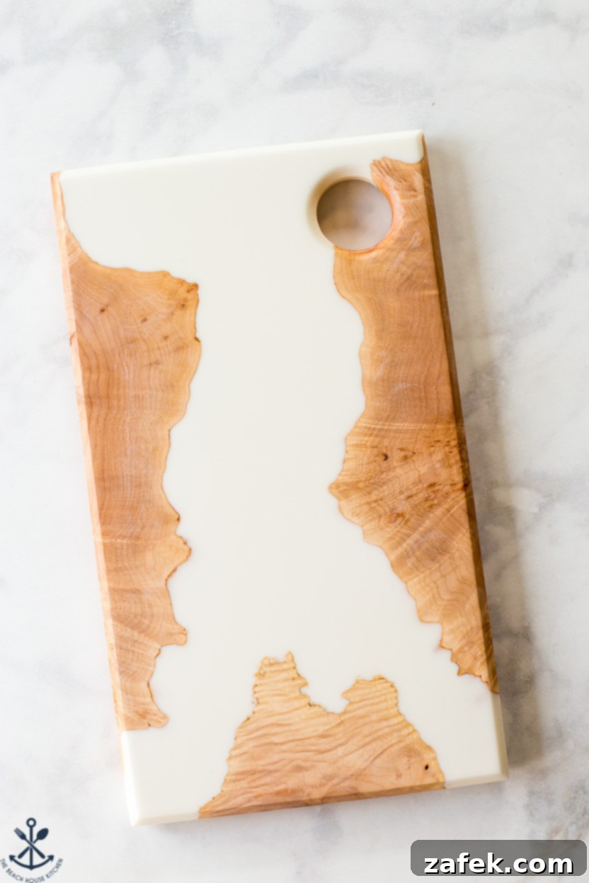 Fireside Pumpkin Old Fashioned 6 An overhead shot showcasing a beautiful white and maple burl charcuterie board, highlighting its intricate wood grain and elegant finish.