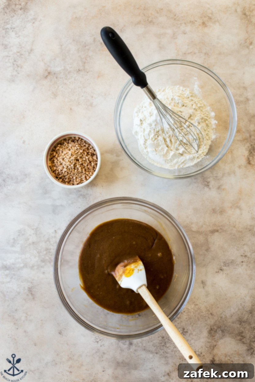 Overhead photo of cookie dough in one bowl, flour in another and toffee bits in another small bowl.