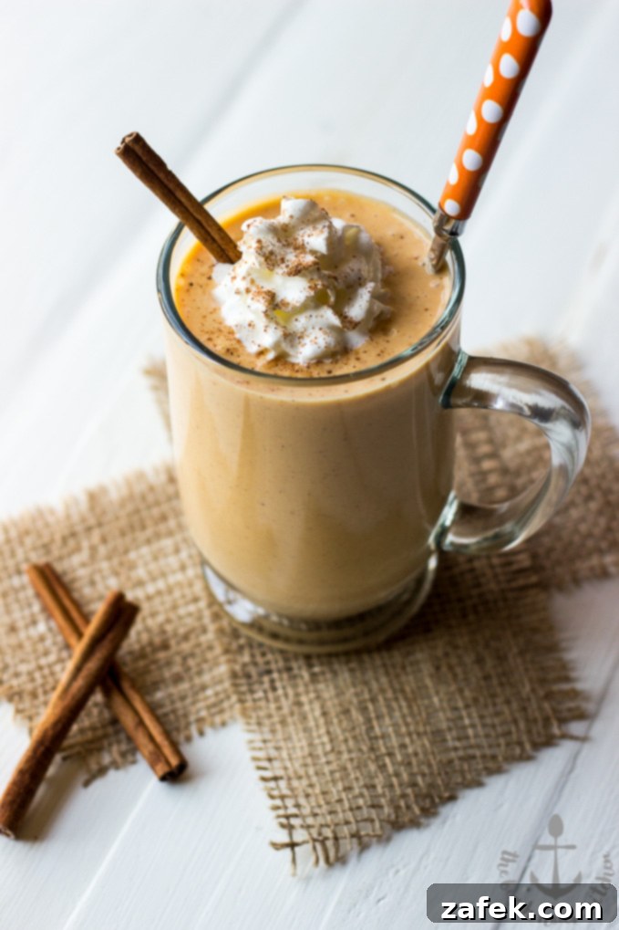 Cozy Spiced Pumpkin Sip 2 Thick and creamy Pumpkin Pie Smoothie in a glass, ready to be enjoyed.
