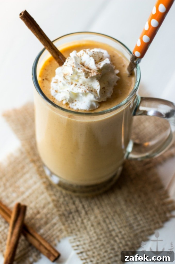 Cozy Spiced Pumpkin Sip 4 Pumpkin Pie Smoothie garnished with a sprinkle of cinnamon, inviting a healthy sip.