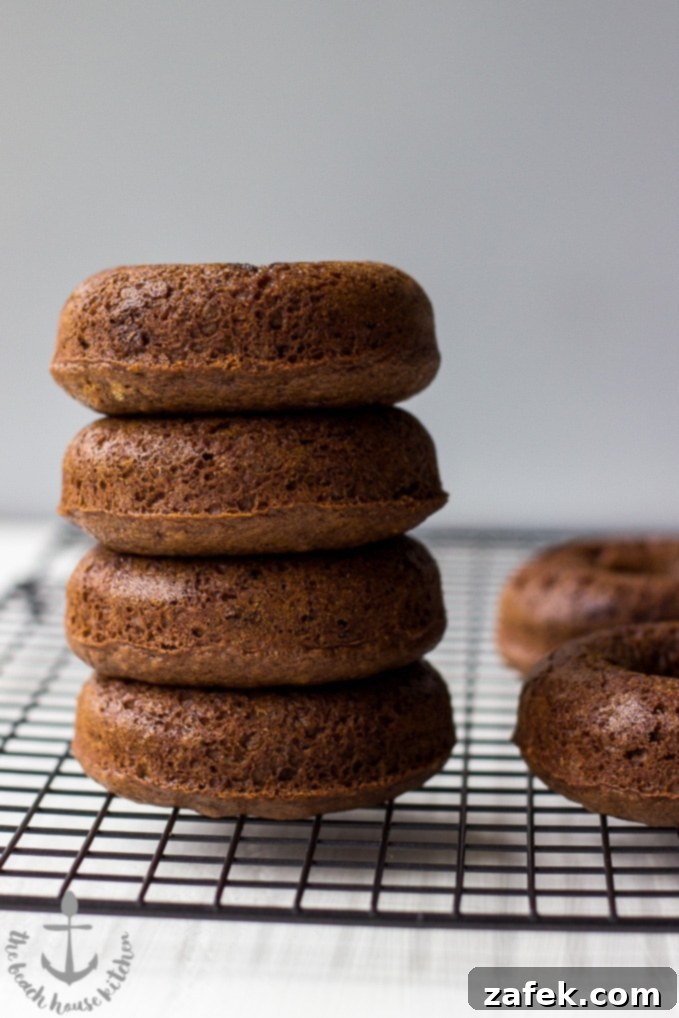 Gingerbread Donut Bliss 4 A stack of freshly baked gingerbread donuts with a glistening glaze, ready to be enjoyed