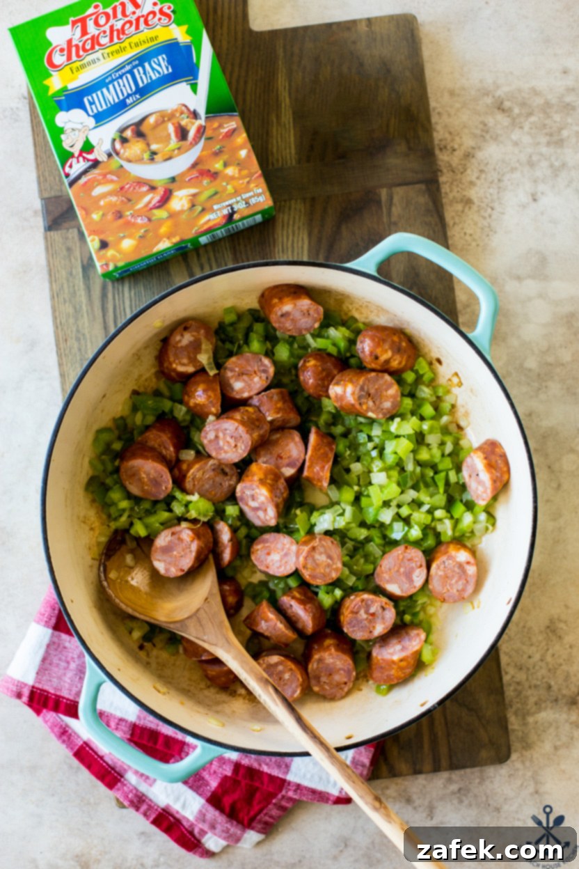 Overhead photo of a skillet of veggies and andouille sausage