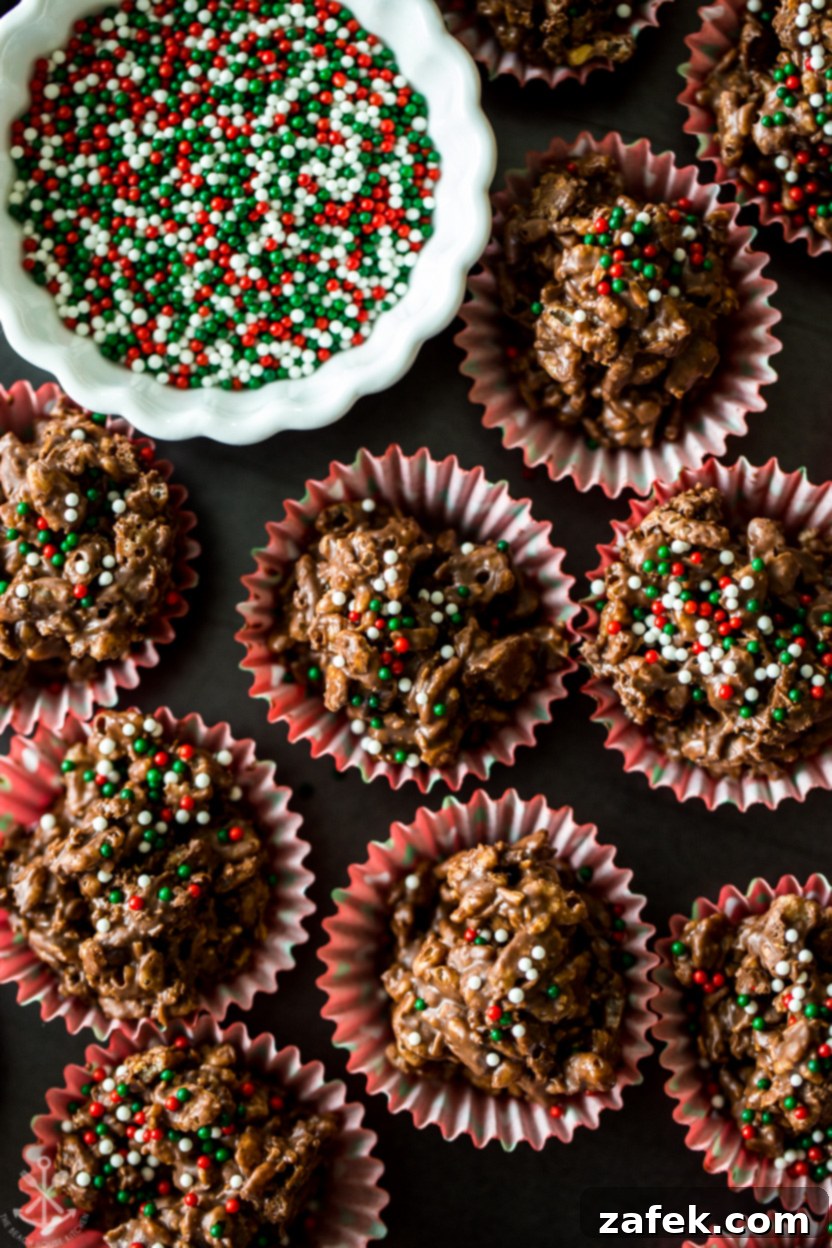 Up close photo of freshly made crispy chocolate coconut crunch cups, artfully arranged on a serving plate with a small bowl of colorful nonpareils in the background, hinting at their festive appeal
