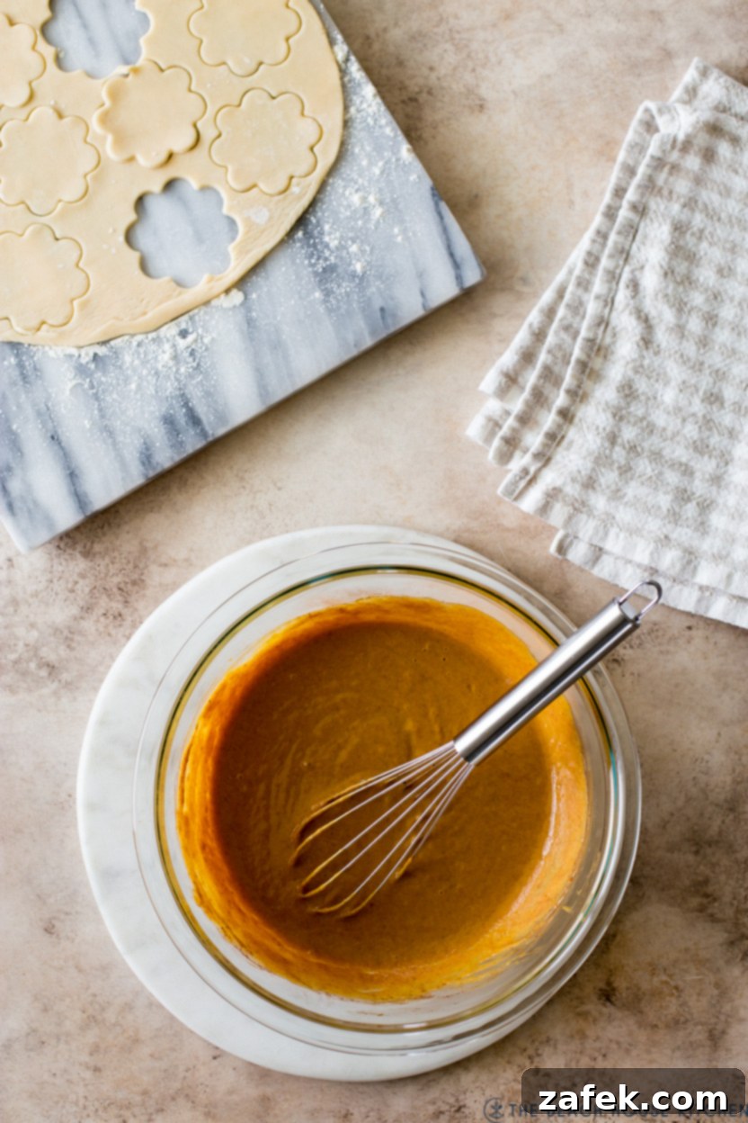 Overhead photo of a glass bowl of pumpkin pie filling